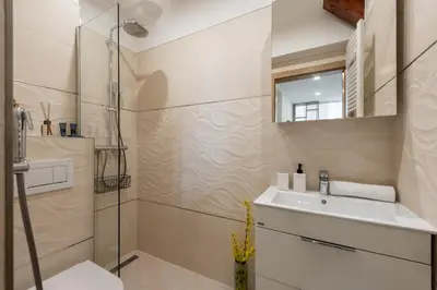 a bathroom with a sink and a shower at Sunset View Apartment in Prague
