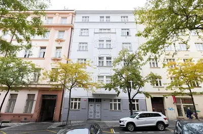 a white building with cars parked in front of it at Sunset View Apartment in Prague