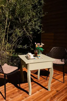 a white table with flowers on it on a patio at Buňka Poteplí in Horní Bezděkov