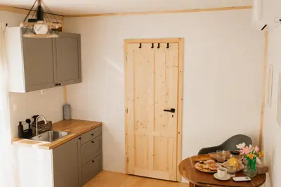 a kitchen with a door and a table with food on it at Buňka Poteplí in Horní Bezděkov