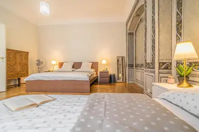 a large bedroom with two beds and a lamp at Luxury Karmelitska 2B apartment in Prague