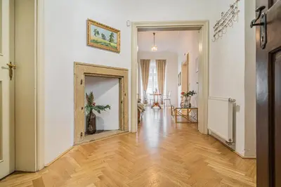 a living room with a wooden floor and a mirror at Luxury Karmelitska 2B apartment in Prague