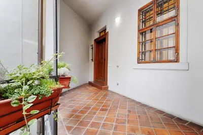 an empty hallway with a door and some plants at Luxury Karmelitska 2B apartment in Prague
