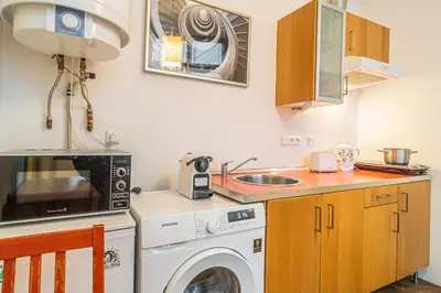 a kitchen with a washing machine and a sink at Karmelitska 1 luxury 1 bedroom in Prague
