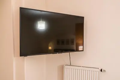 a flat screen tv hanging on a wall at Karmelitska 1 luxury 1 bedroom in Prague