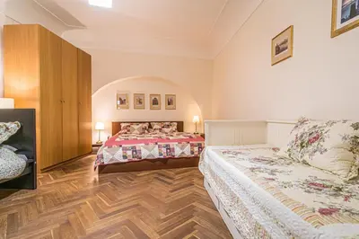 a bedroom with two beds and a wooden floor at Karmelitska 1 luxury 1 bedroom in Prague