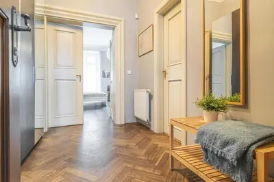 a room with a hallway with a table and a mirror at Karmelitska 2 luxury 1B apartment in Prague