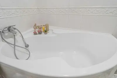 a white bath tub with a shower in a bathroom at Karmelitska 2 luxury 1B apartment in Prague