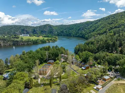 an aerial view of a village next to a river at Moderní chata se zastřešenou terasou v docházkové vzdálenosti na pláž in Nalžovické Podhájí