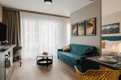 two chairs and a table in front of a window at Avenue Apartments in Prague