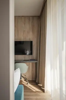 a wooden door with black shelves in a room at Avenue Apartments in Prague