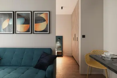 a hotel room with a wooden cabinet and a desk at Avenue Apartments in Prague