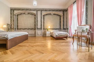 a bedroom with two beds and a table and a chair at 2 Bed Flat - Sleeps 6 - Pets - Wifi in Prague