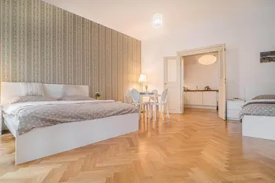 a bedroom with a bed and a table and chairs at 2 Bed Flat - Sleeps 6 - Pets - Wifi in Prague