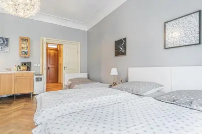a bedroom with two beds and a chandelier at 1 Bed Flat - Sleeps 3 - Pets - Wifi in Prague