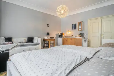 a bedroom with two beds and a chandelier at 1 Bed Flat - Sleeps 3 - Pets - Wifi in Prague
