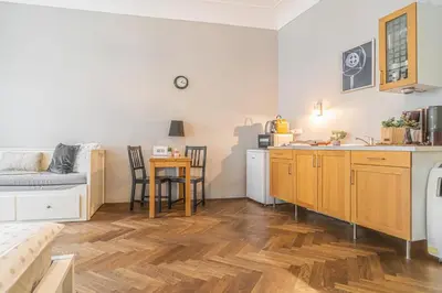 a kitchen and a living room with a table at 1 Bed Flat - Sleeps 3 - Pets - Wifi in Prague