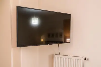 a flat screen tv hanging on a wall at 1 Bed Flat - Sleeps 4 - Pets - Wifi in Prague
