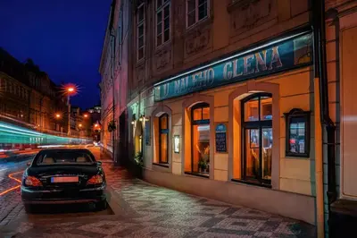 a car parked in front of a building at night at 1 Bed Flat - Sleeps 4 - Pets - Wifi in Prague