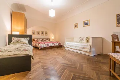 two beds in a room with wooden floors at 1 Bed Flat - Sleeps 4 - Pets - Wifi in Prague