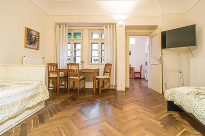 a room with two beds and a table and chairs at 1 Bed Flat - Sleeps 4 - Pets - Wifi in Prague