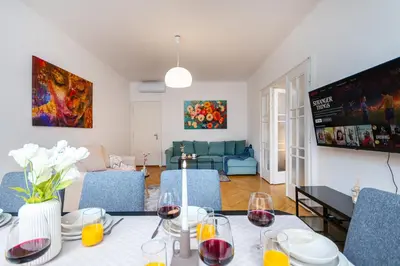 a dining room and living room with a table and chairs at Charles Bridge Historic Centre Elegant Spacious Apartment in Prague