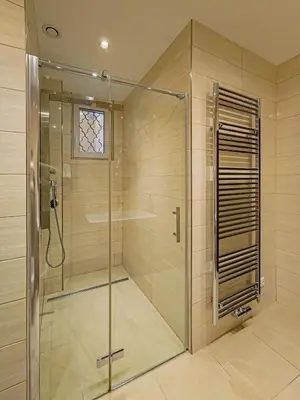 a shower with a glass door in a bathroom at Magnificent Apartment with Sauna and Billiards in Prague