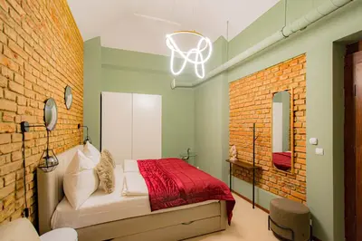 a bedroom with a bed and a brick wall at Magnificent Apartment with Sauna and Billiards in Prague