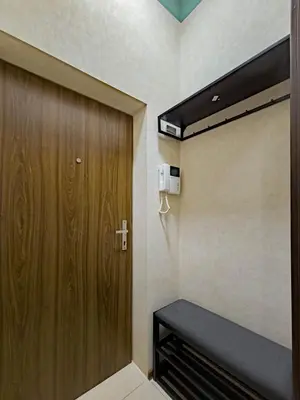 a room with a wooden door and a bench at Magnificent Apartment with Sauna and Billiards in Prague