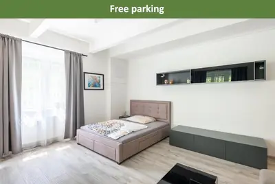 a bedroom with a bed and a large window at Apartment by the metro with private parking in Prague