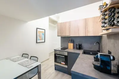 a kitchen with a stove and a counter top at Apartment by the metro with private parking in Prague