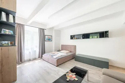a living room with a bed and a couch at Apartment by the metro with private parking in Prague
