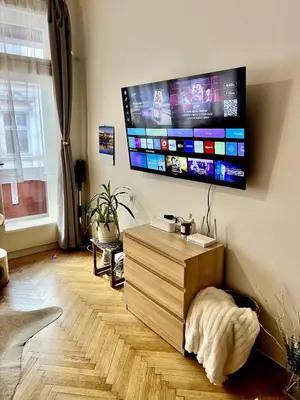 a living room with a flat screen tv on the wall at Cozy private apartment in Prague