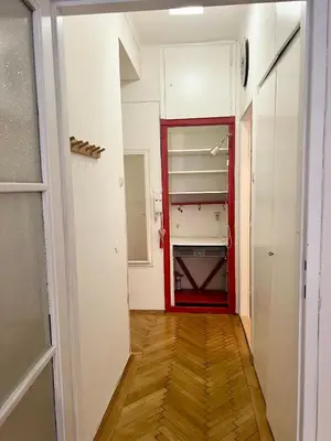 a hallway with a red door and a closet at Cozy private apartment in Prague