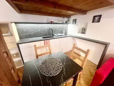 a kitchen with a table and a counter top at Cozy private apartment in Prague