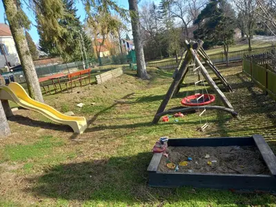 a playground with a swing set and a slide at U Dobroty in Nový Dŭm