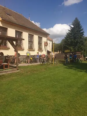 a group of people standing in front of a house at U Dobroty in Nový Dŭm