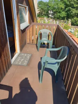 two chairs sitting on the porch of a house at U Dobroty in Nový Dŭm