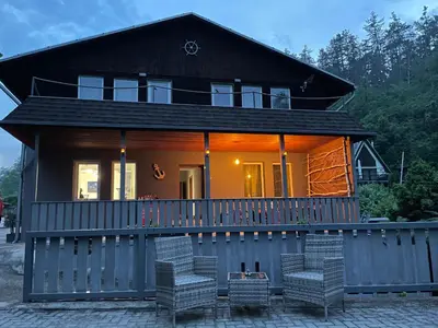 a house with a porch with a fence at Marina Hubenov in Hubenov