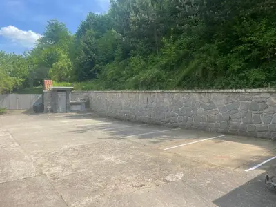 a stone retaining wall next to a parking lot at Marina Hubenov in Hubenov