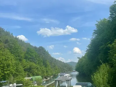 a river with cars parked on the side of it at Marina Hubenov in Hubenov