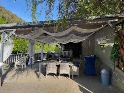a patio with a table and chairs under a canopy at Marina Hubenov in Hubenov