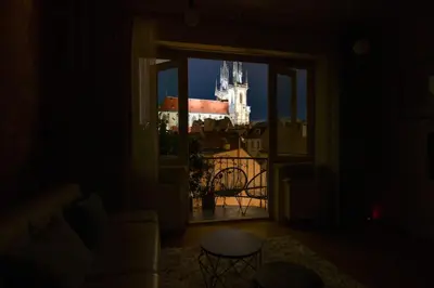 a bedroom with a white bed and a window at Old Town Astronomical Clock Cathedral View Balcony in Prague