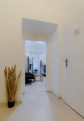 an empty room with a door and a table at Hostel Karlin in Prague