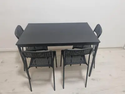 a black table with four chairs around it at Hostel Karlin in Prague