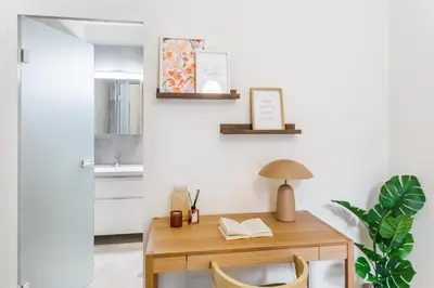 a room with a wooden table and chairs and a sink at Rentero Wenceslas Square Apartments in Prague