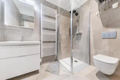 a bathroom with a shower and a toilet and a sink at Rentero Wenceslas Square Apartments in Prague