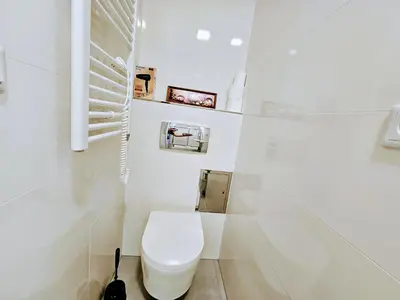 a white bathroom with a toilet in a room at LIVE-INN PRAGUE DELUXE SUITE FOR 1-4 GUESTS, 20 Mins to center, Lift, Gym, Reception, Parking, Roof Terrace, Game & Party in Prague