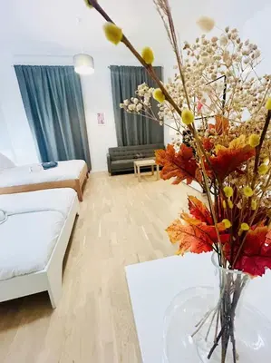 a living room with a vase of flowers on a table at New Design apartment right next Wenceslas Square in Prague