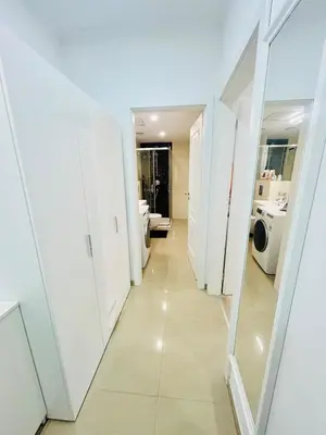 a hallway of a bathroom with white walls at New Design apartment right next Wenceslas Square in Prague
